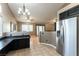 Bright kitchen with stainless steel refrigerator, tile floors, and view to living area at 812 Rio Poco Ct, Henderson, NV 89015