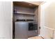 Convenient laundry room featuring newer appliances and shelving for storage at 812 Rio Poco Ct, Henderson, NV 89015