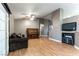 Bright living room featuring hardwood floors, neutral walls, a ceiling fan, and a cozy entertainment center at 812 Rio Poco Ct, Henderson, NV 89015