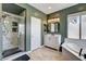 Modern bathroom featuring a glass shower, soaking tub, and stylish vanity with granite countertops at 8212 Swallow Falls St, North Las Vegas, NV 89085