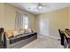 Cozy bedroom with carpet flooring, a window, closet space, and a ceiling fan at 8212 Swallow Falls St, North Las Vegas, NV 89085
