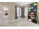 Inviting bedroom featuring neutral walls, tile floors, and a charming built-in bookcase at 8212 Swallow Falls St, North Las Vegas, NV 89085