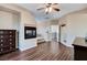 Bedroom featuring a fireplace, wood floors, and neutral walls with great natural light at 8212 Swallow Falls St, North Las Vegas, NV 89085