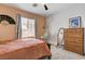 Comfortable bedroom with a modern design features neutral tones, a bed, and a hammock chair at 8212 Swallow Falls St, North Las Vegas, NV 89085