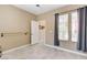 Bright bedroom with neutral walls, tile floors, and natural light, featuring a mounted ballet barre at 8212 Swallow Falls St, North Las Vegas, NV 89085