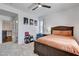 Large bed in well-lit bedroom next to small table with decor plus stairwell and shelves in view at 8212 Swallow Falls St, North Las Vegas, NV 89085