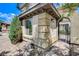 Close-up of the home's stone and stucco exterior with an arched entryway at 8212 Swallow Falls St, North Las Vegas, NV 89085