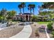 Clubhouse featuring manicured landscaping, palm trees, and a welcoming walkway to the building's entrance at 8212 Swallow Falls St, North Las Vegas, NV 89085
