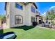 The home has an ample backyard and covered patio with comfortable seating arrangements and a barbecue grill at 8212 Swallow Falls St, North Las Vegas, NV 89085