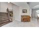 Grand foyer with a staircase, piano, and elegant tile flooring at 8212 Swallow Falls St, North Las Vegas, NV 89085