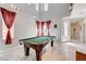 Spacious game room with a pool table and tall windows for natural light at 8212 Swallow Falls St, North Las Vegas, NV 89085