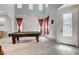 Spacious game room with a pool table and tall windows for natural light at 8212 Swallow Falls St, North Las Vegas, NV 89085
