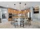 Open-concept kitchen features a granite island with seating and stainless steel appliances at 8212 Swallow Falls St, North Las Vegas, NV 89085