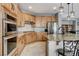 Open kitchen has an island with seating, stainless steel appliances, and ample cabinet space at 8212 Swallow Falls St, North Las Vegas, NV 89085