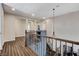 Open second story landing with wood floors, iron decorative banister, and decorative lighting at 8212 Swallow Falls St, North Las Vegas, NV 89085