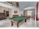 Open-concept living room features a pool table, staircase, piano and elegant decor at 8212 Swallow Falls St, North Las Vegas, NV 89085