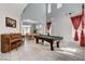 Open-concept living space with a game table, piano, and dining area at 8212 Swallow Falls St, North Las Vegas, NV 89085