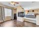 Open-concept bedroom with wood floors, fireplace, and sitting area at 8212 Swallow Falls St, North Las Vegas, NV 89085