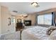 Large main bedroom featuring carpet, neutral walls, and a corner fireplace at 8212 Swallow Falls St, North Las Vegas, NV 89085