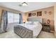 Cozy main bedroom featuring carpet, a tufted headboard, and bright natural light at 8212 Swallow Falls St, North Las Vegas, NV 89085