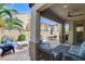 A spacious backyard patio featuring an outdoor fire pit, ample seating, and a view of the surrounding landscape at 8212 Swallow Falls St, North Las Vegas, NV 89085
