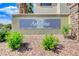 An decorative stone and stucco wall features the community's name, 'Angeline', with shrubs planted around it at 8212 Swallow Falls St, North Las Vegas, NV 89085