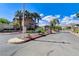 A landscaped street entrance with palm trees, decorative rock, and street signs at 8212 Swallow Falls St, North Las Vegas, NV 89085