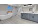 Modern bathroom featuring double vanities, soaking tub, and walk-in shower with white marble surround at 8232 Ocean Terrace Way, Las Vegas, NV 89128