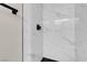 Modern shower with marble-look tile, black hardware, and sleek design at 8232 Ocean Terrace Way, Las Vegas, NV 89128