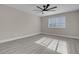 Bedroom featuring natural light, gray wood floors, and modern ceiling fan at 8232 Ocean Terrace Way, Las Vegas, NV 89128