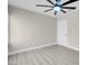 Simple bedroom offering light gray wood-look flooring and a modern ceiling fan at 8232 Ocean Terrace Way, Las Vegas, NV 89128