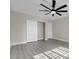 Spacious bedroom with light gray wood floors and double closets for ample storage at 8232 Ocean Terrace Way, Las Vegas, NV 89128