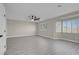Large bonus room with light gray wood floors, two windows with shutters and neutral paint at 8232 Ocean Terrace Way, Las Vegas, NV 89128