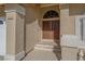 Inviting front entrance with a secure double door and textured stucco walls at 8232 Ocean Terrace Way, Las Vegas, NV 89128