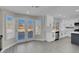 Bright kitchen features white cabinets, stainless steel appliances, gray cabinets, an island and lots of natural light at 8232 Ocean Terrace Way, Las Vegas, NV 89128