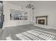 A view of the living room showing the fireplace and natural light with open access to the kitchen at 8232 Ocean Terrace Way, Las Vegas, NV 89128