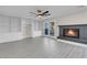 This bright living room features a fireplace, built-in cabinets, and a glass door leading to the patio at 8232 Ocean Terrace Way, Las Vegas, NV 89128