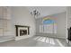 Bright living room featuring a fireplace, tall vaulted ceilings, large windows with shutters, and light gray floors at 8232 Ocean Terrace Way, Las Vegas, NV 89128