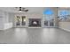Spacious living room with a fireplace, built-in cabinets and glass doors with a backyard view at 8232 Ocean Terrace Way, Las Vegas, NV 89128