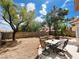 Backyard area with patio, desert landscaping, block wall, and outdoor table with seating at 8753 Fountain Island Dr, Las Vegas, NV 89147