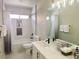 Bright bathroom featuring a shower-tub combo, with updated vanity, mirror and counterspace at 8753 Fountain Island Dr, Las Vegas, NV 89147