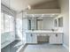 Bright bathroom showcasing double vanity with white cabinets and a glass-enclosed shower at 8753 Fountain Island Dr, Las Vegas, NV 89147
