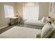 Bright bedroom with twin beds, soft lighting, and a work desk at 8753 Fountain Island Dr, Las Vegas, NV 89147