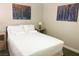 A comfortable bedroom featuring soft lighting, and modern artwork at 8753 Fountain Island Dr, Las Vegas, NV 89147