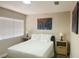 Cozy bedroom with a queen-sized bed, neutral walls, and an abstract art piece at 8753 Fountain Island Dr, Las Vegas, NV 89147