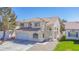 Charming stucco home featuring a red tile roof, arched entryway, and a spacious two-car garage at 8753 Fountain Island Dr, Las Vegas, NV 89147