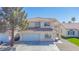 Charming stucco home featuring a red tile roof, arched entryway, and a spacious two-car garage at 8753 Fountain Island Dr, Las Vegas, NV 89147