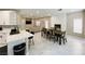 Open concept living and dining area featuring a fireplace, modern lighting, and neutral decor at 8753 Fountain Island Dr, Las Vegas, NV 89147