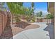 Spacious backyard featuring a paved patio area, low-maintenance landscaping, and privacy wall at 9009 Ochoa St, Las Vegas, NV 89143