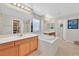 Bright bathroom featuring a large soaking tub, dual sinks, and a separate shower and walk-in closet at 9009 Ochoa St, Las Vegas, NV 89143